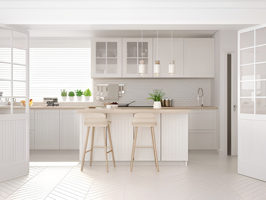 Modern white kitchen with island, wooden stools, pendant lights, plants, glass cabinets—latest kitchen colour trends
