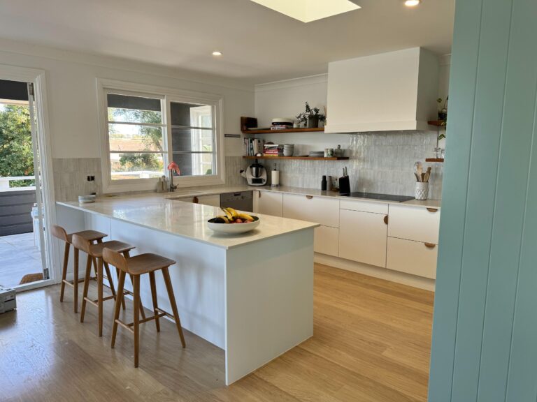 Modern Collaroy Plateau kitchen with white cabinets, large island, and refined door & benchtop reface.