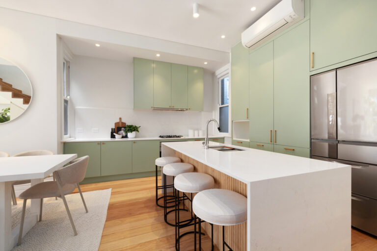Modern kitchen with green cabinets, white countertops, Manly Door & Benchtop Reface, and adjacent dining area.