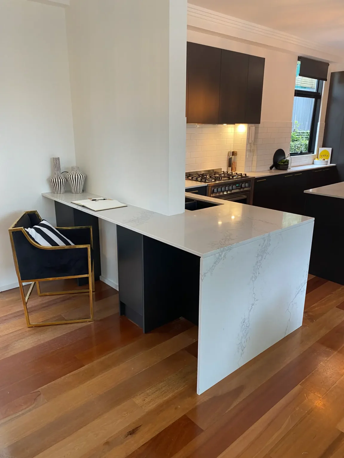 Modern kitchen renovation in Dee Why with a white stone waterfall island bench and integrated study nook feature.